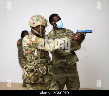 Personal Sgt. Daniel Nibbs (links) neben Sgt. First Class Raynard Francis (rechts), Durchführung einer virtuellen Simulation Mystery-Veranstaltung in der D&J Shooting Gallery während des Best Warrior Competition, St. Croix, 12. März 2021. Der VING-BWC ist ein kulminierender Test, bei dem die konkurrierenden Unteroffizierinnen und Soldaten fünf Tage lang an verschiedenen Herausforderungen teilnehmen, darunter das Abfeuern von Waffen, die Landnavigation, den Army Physical Fitness Test und andere verschiedene Veranstaltungen. Diese Herausforderungen werden das Wissen, die technischen und taktischen Fähigkeiten, die körperliche Ausdauer, die mentale Härte und die allgemeine Kampfbereitschaft jedes einzelnen Teilnehmers auf die Probe stellen. Stockfoto