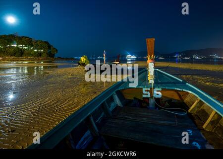 Langzeitbelichtung Nachtbild von langen Schwanz Holzboote auf dem Sand eines thailändischen Strandes Stockfoto