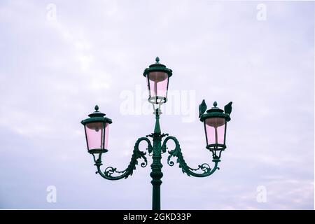 Zwei Tauben auf einem schönen alten Laternenpfosten Stockfoto