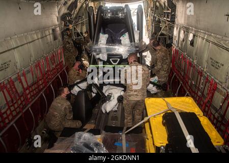 Airmen laden Fracht auf einen HC-130J Combat King II am Springfield-Beckley Municipal Airport, Ohio, 23. März 2021. Die Ladung war ein ELEKTRONISCHES vertikales Start- und Landeflugzeug, das das 79. Rettungsgeschwader von Ohio nach Texas transportierte. Diese Transportbemühungen dienten als Proof of Concept, da der 355. Flügel plant, eVTOL in bevorstehende Übungen zu integrieren, um seine agilen Kampfarbeitsfähigkeiten zu fördern. Stockfoto