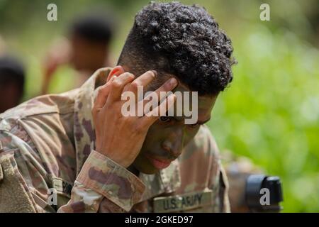 Soldaten, die einer Kompanie zugeordnet sind, 29. Brigade-Ingenieur-Bataillon, 3. Infanterie-Brigade-Kampfteam, 25. Infanterie-Division tragen Tarnanstrich auf, während sie sich darauf vorbereiten, am 30. März 2021 in Schofield Barracks, Hawaii, Trainingsbahnen für Live-Feuerübungen durchzuführen. Stockfoto