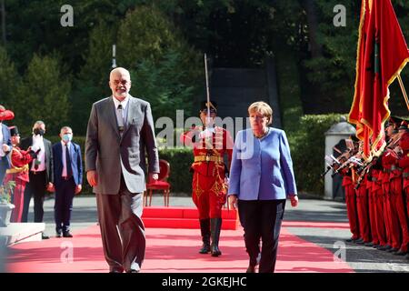 Tirana, Albanien. September 2021. Der albanische Premierminister Edi Rama (L) und die deutsche Bundeskanzlerin Angela Merkel inspizieren die Ehrenwache im Palast der Brigaden in Tirana, Albanien, 14. September 2021. Quelle: Gent Oluzi/Xinhua/Alamy Live News Stockfoto