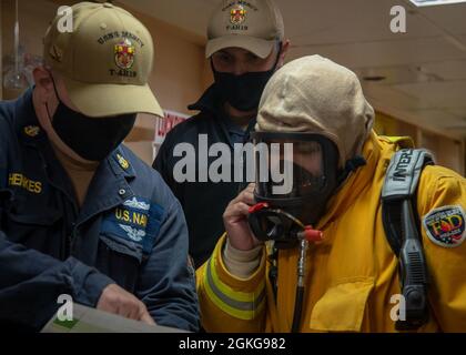210415-N-DA693-1074 PAZIFISCHER OZEAN (APR. 15, 2021) Seeleute, die an Bord des Militärkrankenhauses des Sealift Command USNS Mercy (T-AH 19) der eingeschifften medizinischen Behandlungseinrichtung zugewiesen wurden, koordinieren sich während einer Übung am 15. April an einem Damage Control Schließfach. Mercy ist auf dem Weg vor der Küste Südkaliforniens, um die dynamischen Grenzflächentests durchzuführen, bei denen die Luftfahrteinrichtungen des Schiffes auf Kompatibilität mit der V-22 Osprey und MH-60 Seahawk überprüft und bei widrigen Wetterbedingungen Start- und Wiederherstellungsfenster festgelegt werden. Mercy kehrte kürzlich nach einer regelmäßigen Überholung in P in seinen Heimathafen in San Diego zurück Stockfoto