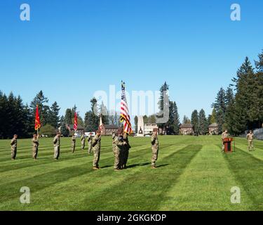 Mit dem Monument der 91. Division am Ende des Watkins-Feldes als Hintergrund, dem scheidenden Kommandanten der 5. Sicherheitskräfte-Assistenzbrigade, Brig. General Curtis Taylor hält während der Übergabe der Kommandozeremonie auf der Joint Base Lewis-McChord, Washington, am 16. April 2021, Bemerkungen. Stockfoto