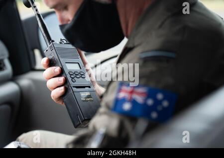 Ein Luftwaffenflieger der Royal Australian Air Force aus der Squadron No. 2 betreibt am 20. April 2021 ein Radio auf dem Honolulu International Airport, Hawaii. Die Luftbesatzung der RAAF reiste nach Hawaii, um an der Übung Pacific Edge 21 teilzunehmen und sich mit der Hawaii Air National Guard F-22 Raptors zu integrieren. Die australischen Dienstmitglieder flogen mit den Raptors an Bord einer E-7A Wedgetail, einem Kommando- und Kontrollflugzeug. Stockfoto