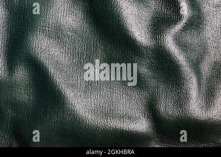 Textur Hintergrund Foto von grünen farbigen gefalteten Ledermaterial. Stockfoto
