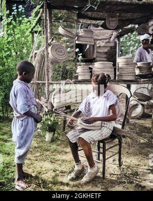 1930ER AFRICAN AMERICAN GULLAH JUNGE STEHEND BEOBACHTETE MÄDCHEN WEBKORB AM STAND MEHRERE KÖRBE ZUM VERKAUF SOUTH CAROLINA USA - N1202C HAR001 HARS SCHWESTER 1 JUGENDLICH STIL LIFESTYLE GESCHICHTE FRAUEN BRÜDER LAND HAUS LEBEN VEREINIGTE STAATEN KOPIEREN RAUM FREUNDSCHAFT HALBE LÄNGE KUNSTHANDWERK TRADITIONELLE VEREINIGTE STAATEN VON AMERIKA MÄNNER KÜNSTLER HANDWERK GESCHWISTER SCHWESTERN KÜNSTLER FÄHIGKEITEN VERKAUF SPRACHE AFROAMERIKANER AFROAMERIKANISCHE SCHWARZE ETHNIE CAROLINA LOKALE BERUFE GESCHWISTER SÜD KUNST VERKAUFEN TRADITIONEN KÖRBE KREOLISCHE KREATIVITÄT HANDARBEITEN JUGENDLICHE JUGENDLICHE PRE-TEEN PRE-TEEN MÄDCHEN STRASSENRAND SC MEHRERE SÜD CAROLINA Stockfoto