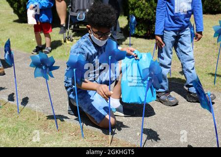 Noah Mills, 9, pflanzt ein Windrad während der U.S. Army Garrison Japan Army Community Service Windrad-Pflanzung zur Gedenkfeier des National Child Abuse Prevention Month in der Sagamihara Family Housing Area Library, SFHA, Japan, April 23. Stockfoto