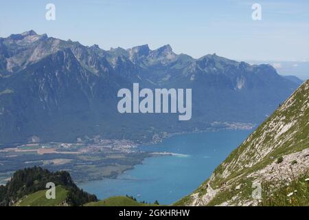 Landschaft eines Sees umgeben von felsigen Hügeln im Regionalpark Gruyere Pays-d'Enhaut, Schweiz Stockfoto