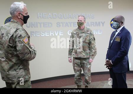 Maj. General Gregory J. Mosser, Mitte, stellvertretender Generalkommandant, Reserve-Kommando der US-Armee und Brig. General Robert S. Cooley Jr., links, Stabschef des US Army Reserve Command, begrüßt den pensionierten US Marine Corps LT. General Walter Gaskin im Hauptquartier des US Army Reserve Command in Fort Bragg, N.C., 27. April 2021. Gaskin ist derzeit Sekretär des North Carolina Department of Military and Veterans Affairs. Stockfoto