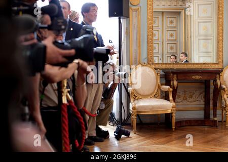 Pressevertreter beobachten, wie Präsident Barack Obama am 6. Juni 2009 bei einem bilateralen Treffen mit dem französischen Präsidenten Nicolas Sarkozy in Caen, Frankreich, zusammenkommt. (Offizielles Foto des Weißen Hauses von Pete Souza) Dieses offizielle Foto des Weißen Hauses wird zur Veröffentlichung durch Nachrichtenorganisationen und/oder zum persönlichen Druck durch die Betreffzeile(en) des Fotos zur Verfügung gestellt. Das Foto darf in keiner Weise manipuliert oder in Materialien, Anzeigen, Produkten oder Werbeaktionen verwendet werden, die in irgendeiner Weise die Zustimmung oder Billigung des Präsidenten, der ersten Familie oder des Weißen Hauses nahelegen. Stockfoto