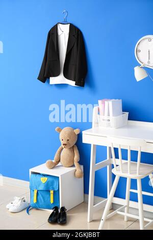 Stilvolle Schuluniform und Rucksack im Innenraum des Raumes Stockfoto