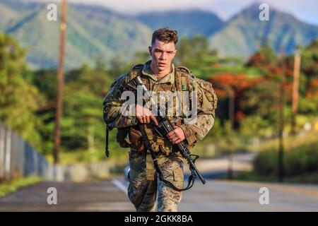 Schofield Barracks, HI – SPC. Micah Waterman, ein Armeekanonen-Besatzungsmitglied (13B), der Bravo Battery, dem 3. Bataillon, dem 7. Artillerieregiment und der 25. Infanterie-Division Artillerie zugeordnet ist, beendet während des Soldier of the Year Competition der 25. Infanterie-Division in Schofield Barracks, Hawaii, 13. Mai 2021, einen 12-Meilen-Ruck-marsch. Stockfoto