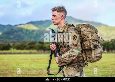 Schofield Barracks, HI – SPC. Micah Waterman, ein Armeekanonen-Besatzungsmitglied (13B), der Bravo Battery, dem 3. Bataillon, dem 7. Artillerieregiment und der 25. Infanterie-Division Artillerie zugeordnet ist, beendet den 12 Meilen-Ruck-marsch während des Soldier of the Year-Wettbewerbs der 25. Infanterie-Division in Schofield Barracks, Hawaii, 13. Mai 2021. Stockfoto