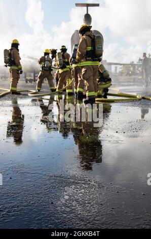 Feuerwehrleute des 142. Flügels der Oregon Air National Guard führen eine Live-Feuerübung mit Marine Corps-Feuerwehrleuten auf der Marine Corps Base, Hawaii, 14. Mai 2021 durch. Dieser Brand ist Teil einer größeren gemeinsamen Übung, die das Einlernen von Flugzeugen, Ausstiegsschulungen sowie die gemeinsame Schulung und Betreuung weniger erfahrener Feuerwehrleute umfasst. Stockfoto