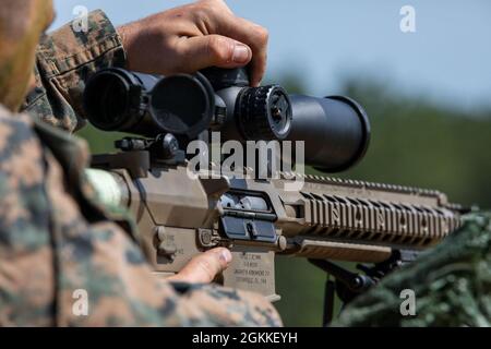 Ein Marine mit der 3rd Force Reconnaissance Company, 4th Marine Division, passt seinen Umfang während des Scharfschützentrainings in Camp Shelby, Mississippi, am 16. Mai 2021 an. Marinesoldaten trainieren mit dem halbautomatischen Scharfschützensystem M110, einem Antipersonengewehr und Leichtgewehr, das 7.62-mm-Patronen abfeuert, um die Fähigkeiten im Langstreckenschießen zu erhalten. Stockfoto