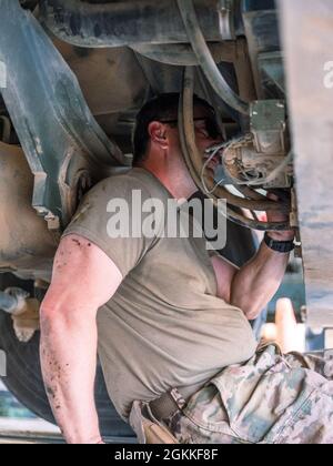 Sgt. Bradley Koopman, ein Mechaniker für Radfahrzeuge in der Headquarters Support Company, 640. Aviation Support Battalion, inspiziert die Unterseite eines Fahrzeugs in Camp Buehring, Kuwait, während er zur Unterstützung der Operation Inhärent Resolve und der Operation Spartan Shield eingesetzt wird. Stockfoto