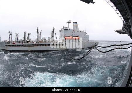 210518-N-VJ326-1023 PAZIFISCHER OZEAN (18. Mai 2021) – Flottenfüller USNS Henry J. Kaiser (T-AO 187) führt eine Auffüllung auf See mit amphibischem Angriffsschiff USS Tripoli (LHA 7), Mai 18 durch. Tripolis führt derzeit Routineoperationen in der dritten US-Flotte durch. Stockfoto