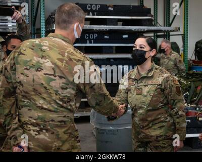 Der General der US-Armee, Daniel R. Hokanson, Chef des National Guard Bureau, überreicht eine Münze an den Senior Airman Meilany Caimares, einen medizinischen Techniker der 103. Medical Group, im Small Air Terminal der Bradley Air National Guard Base in East Granby, Connecticut, 20. Mai 2021. Hokanson besuchte Soldaten und Luftwaffe der Connecticut National Guard und erhielt einen ersten Blick auf die Missionen des 103. Luftlift-Flügels und der Company C, 3-142. Aviation Regiment. Stockfoto