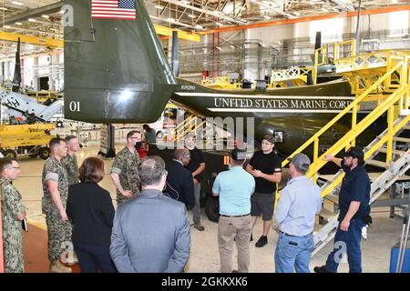 Fleet Readiness Center East Kommandeur Col. Thomas A. Atkinson, Sekretär Walter Gaskin vom North Carolina Department of Military and Veterans Affairs und andere Besucher, darunter die Führung der Marine Corps Air Station Cherry Point, Sprechen Sie mit Veteranen, die an der V-22 Osprey-Flugzeuglinie von FRCE arbeiten, während einer Besichtigung der Anlage im Mai 20. Gaskin besuchte FRCE im Rahmen einer größeren Zusammenarbeit mit der Marine Corps Air Station Cherry Point und den Mieterorganisationen der Station, darunter FRCE und die Naval Health Clinic Cherry Point. Stockfoto