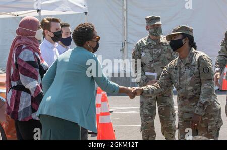 US Army Brig. Gen. Janeen Birckhead, Kommandantin der Impfint Equity Task Force in Maryland, begrüßt Osaremen Okolo, einen Politikberater, der dem COVID-19 Response Team des Weißen Hauses im staatlich geführten Pilotgemeinschaftsimpfungszentrum in Greenbelt, Maryland, am 21. Mai 2021, zugewiesen wurde. Das U.S. Northern Command setzt sich über die U.S. Army North weiterhin dafür ein, die Federal Emergency Management Agency im Rahmen der Reaktion der gesamten Regierung auf COVID-19 weiterhin flexibel und flexibel zu unterstützen. Stockfoto