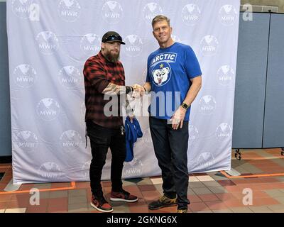 General Peter Andrysiak, Generalkommandant der US-Armee in Alaska, überreicht vor Fort Wainwright's Sommerkonzert am 5. Juni eine Münze und ein T-Shirt an den Country-Sänger Brantley Gilbert. Das Konzert im Freien zeigte Auftritte von Rapper und Filmstar Chris 'Ludacris' Bridges, c Gilbert und dem Komiker Ronnie Jordan. Stockfoto