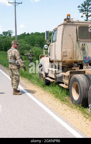 Personal Sgt. James Dean, ein Beobachtertrainer/Trainer mit 1. Bataillon, 33. Brigade-Ingenieur-Bataillon, 181. Multifunktionale Trainingsbrigade, Bodenführer eines M915A5 Line-Haul-Traktorwagens aus einem Graben an einer Straße 8. Juni 2021, auf Fort McCoy, Wis. die Fahrzeuge mussten sicher aus dem Graben gefahren werden, ohne den Kipppunktwinkel jedes Lkw zu beeinträchtigen. Stockfoto