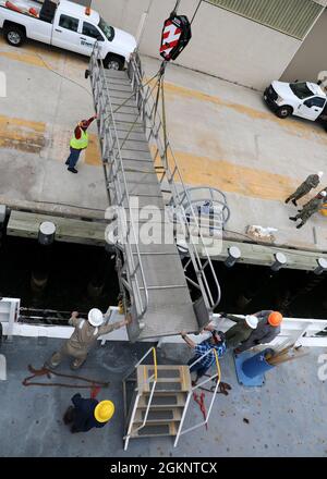 210608-N-OH262-0845 NORFOLK, VA. (8. Juni 2021)--zivile Seeleute, die dem ozeanographischen Surveyschiff des Militärkommandos USNS Bruce C. Heezen (T-AGS 64) zugewiesen wurden, positionieren die Gangway, die von Personal zum Aussteigen des Schiffes verwendet wird, während das Schiff in die Marinestation Norfolk einfährt, 8. Juni. Die Seeleute, die USNS Bruce C. Heezen besetzen, sind bei der beauftragten Betreibergesellschaft Ocean Ships, Inc. Beschäftigt Stockfoto