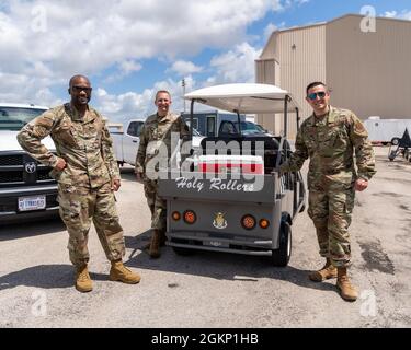 SMSgt. Paul Williams, Kaplan (Maj.) John Rollyson und 2nd LT. Brian A. Harris, Homestead Chaplain Corps, stehen neben dem Wagen des Kaplan, der als „Holly Rollers“ bezeichnet wird, auf der Homestead Air Reserve Base, FL., 9. Juni 2021. 2. LT. Brian A. Harris beendete seine erste Bewertungstour mit dem Homestead Chaplain Corps und brachte ihn einen Schritt näher, ein Militärkaplan zu werden. Stockfoto