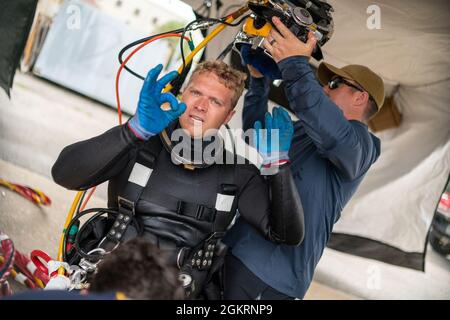 VIRGINIA BEACH, VA. – (21. Juni 2021) Navy Diver 2nd Class Matthew McDorman, zugewiesen an Mobile Diving Salvage Unit (MDSU) 2, Firma 2-5, signalisiert nach der Durchführung von oberflächenversorgten Tauchoperationen ein „OK“. MDSU 2, gegründet von der Joint Expeditionary Base Little Creek - Fort Story, ist eine kampfbereite Expeditionstruppe, die weltweit zur Unterstützung aller Tauch- und Bergungsoperationen eingesetzt werden kann. Stockfoto