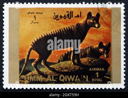UMM AL-QUWAIN - UM 1972: Eine im Umm al-Quwain gedruckte Marke zeigt den Tasmanischen Wolf, Thylacinus Cynocephalus, der größte bekannte fleischfressende Mars Stockfoto