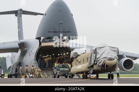 Die Mitglieder des Boeing-Wartungsteams, die Laderampen der 9. Airlift Squadron und die Rampendienste der 436. Aerial Port Squadron laden einen CH-47F Chinook-Hubschrauber an Bord einer C-5M Super Galaxy auf der Dover Air Force Base, Delaware, 26. Juni 2021 hoch. Zwei Chinooks wurden im Rahmen des ausländischen militärischen Verkaufsprogramms der US-Regierung auf das Flugzeug geladen. Die Allianz zwischen den USA und Australien ist ein Anker für Frieden und Stabilität in der Indo-Pazifik-Region und weltweit. Stockfoto