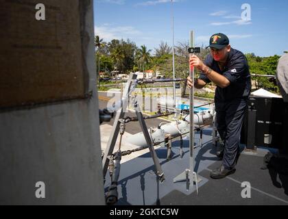 210628-N-RL695-1323 SANTO DOMINGO, DOMINIKANISCHE REPUBLIK - (28. JUNI 2021) -- Elektriker Mate 2nd Class Justin Cross, der dem Freedom-Variant Littoral Combat Ship USS Sioux City (LCS 11) zugewiesen wurde, führt Wartungsarbeiten an einem visuellen Glide-Neigungsanzeiger durch, während das Schiff kurz in Santo Domingo, Dominikanische Republik, zum Tanken und Nachfüllen, am 28. Juni 2021 anhält. Sioux City wird in den Einsatzbereich der 4. US-Flotte entsandt, um die Mission der Joint Interagency Task Force South zu unterstützen, die auch Einsätze zur Bekämpfung des illegalen Drogenhandels in der Karibik und im Ostpazifik umfasst. Stockfoto