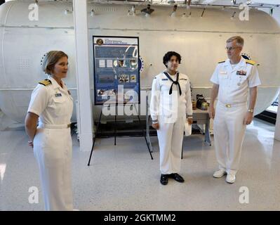 Hinterer Adm. Tim Weber, Commander, Naval Medical Forces Pacific, überreicht eine Münze an Hospital Corpsman 3rd Class Victoria Diaz, das dem Marine Submarine Medical Research Laboratory zugewiesen wurde Stockfoto