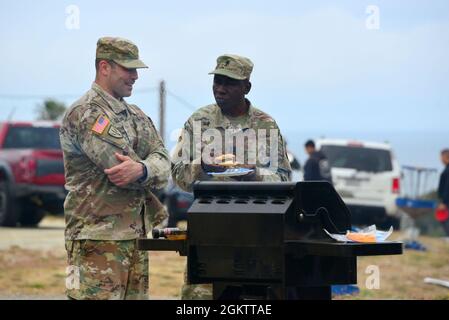 Kaplan (Capt.) Yaw Agbenu, rechts, und Maj. Steve Gluck sprechen, während sie während des 229. Cadre Appreciation Day des Militärgeheimdienstes im Presidio of Monterey, Kalifornien, am 1. Juli einen Grill beaufsichtigen. Stockfoto