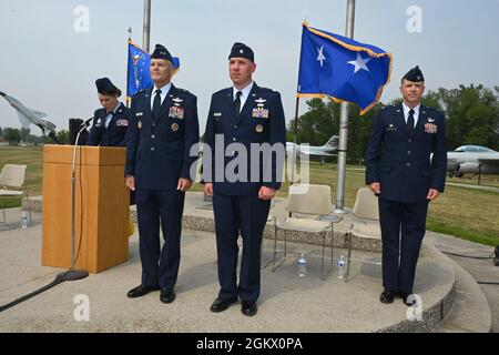 Von links nach rechts, Tech. Sgt. Shelly Fink liest die Werbebestellung als Maj. Gen. (ausgeschieden) Brian Neal, ehemaliger stellvertretender Direktor der Air National Guard, Col. Chris Domitrovich, Vizekommandant des 119. Flügels, Und Col. Mitch Johnson, der Kommandant des 119. Flügels, steht auf der Plattform während der Beförderung zum Oberst für Domitrowitsch auf der North Dakota Air National Guard Base, Fargo, N.D., 14. Juli 2021. Stockfoto