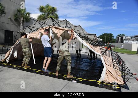 Mitglieder der 81. Medizinischen Gruppe bauen ein Dekontaminationszelt während einer 81. MDG-Funktionsübung hinter dem Keesler Medical Center auf dem Keesler Air Force Base, Mississippi, 15. Juli 2021. Das Szenario beinhaltete eine Explosion von Chlorflaschen, die bei mehreren Opfern Verbrennungen und andere Verletzungen verursachte. Die Massenübung wurde durchgeführt, um sich auf die realen Ereignisse vorzubereiten, indem die Möglichkeiten zur Katastrophenhilfe gestärkt wurden. Stockfoto