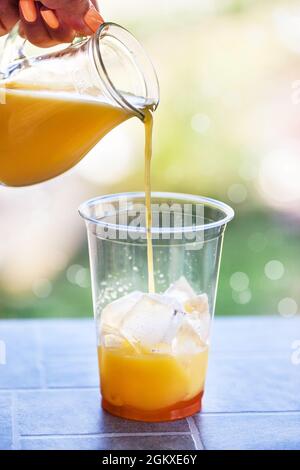 Bumble-Kaffee zubereiten - Erfrischung im Sommer Eiscocktail mit Espresso, Orangensaft, Karamellsirup und Eis Stockfoto