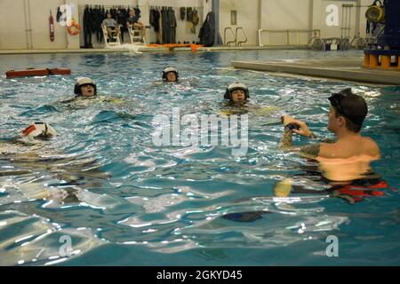 PENSACOLA, Florida (27. Juli 2021) Studenten des Aviation Survival Training Center (ASTC) Pensacola nehmen an einem Wasserüberlebenstraining Teil. ASTCs im ganzen Land bieten sichere und effektive Hochrisiko-Überlebens- und Humanleistungsschulungen unter dem Naval Survival Training Institute (NSTI), einer Abteilung des Navy Medicine Operational Training Command (NMOTC). Stockfoto