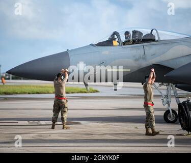 US Air Force Airmen von der 67. Flugzeugwartungseinheit marshall F-15C Eagles beim Abflug vom Kadena Air Base, Japan zur Unterstützung der Übung Red Flag-Alaska, 29. Juli 2021. Die Mobilisierung einer Flotte von F-15C Eagles für den Flug zur Ausübung von Red Flag-Alaska erforderte Fachwissen und Arbeitskraft, aber die 44. Flugzeugwartung-Einheit konnte dies nicht allein erreichen. Flügelmänner aus der 18. Maintenance Group sowie das 18. Logistics Readiness Squadron spielten eine entscheidende Rolle für den Erfolg der Mission. Stockfoto