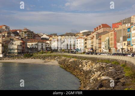 Teilansicht der Touristenstadt La Guardia (A Guarda) vor dem Hafen mit Booten im Wasser. Galicien. Spanien Stockfoto