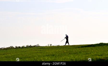 Brighton UK 16. September 2021 - ein Wanderer am frühen Morgen genießt die Mischung aus Sonnenschein und Nebel am Devils Dike entlang des South Downs Way nördlich von Brighton : Credit Simon Dack / Alamy Live News Stockfoto