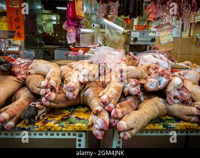 Großer Schweineknöchel, der auf dem asiatischen traditionellen Bauernmarkt in Taiwan verkauft wird. Frische rohe Schweinebeine im Stall zum Verkauf auf dem Street Food Markt Stockfoto