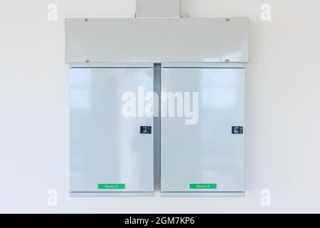 Elektroschaltschrank mit Schild an der Wand. Elektroschrank mit Warnschildern und Vorhängeschlössern. Stockfoto