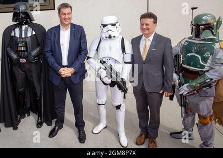 Nürnberg, Deutschland. September 2021. Markus Söder (l.), Parteivorsitzender der CSU und Ministerpräsident Bayerns, und Wolfgang Heckl (r.), Generaldirektor des Deutschen Museums, stehen bei der Eröffnung der neuen Niederlassung des Deutschen Museums Nürnberg als Figuren aus dem Film "Star Wars" gekleidet zwischen Schauspielern. Das Museum präsentiert Zukunftsthemen und diskutiert ethische Fragen. Nach eigenen Angaben ist es eines von vier zukünftigen Museen weltweit. Quelle: Daniel Karmann/dpa/Alamy Live News Stockfoto