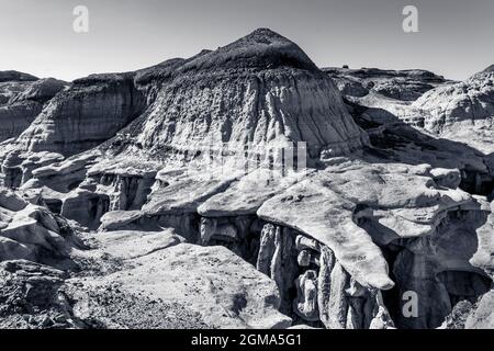 Sandsteinregale bilden Zungenformationen über den Schluchten der Bisti Badlands Stockfoto