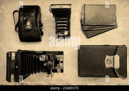 Vintage-Kameras mit Gehäusen auf hellem Hintergrund. Draufsicht Stockfoto