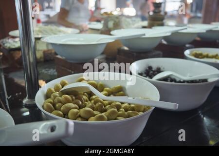 Verschiedene eingelegte Oliven auf Tellern Stockfoto