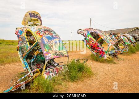 Bemalte Volkswagen Käfer, halb vergraben in einem Winkel auf der Slug Bug Ranch Amarillo Texas auf der Route 66 Stockfoto