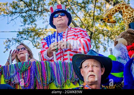 Mardi Gras Nachtschwärmer reiten auf einem Mardi Gras Festwagen während der Joe Cain Day Mardi Gras Parade, 26. Februar 2017, in Mobile, Alabama. Stockfoto